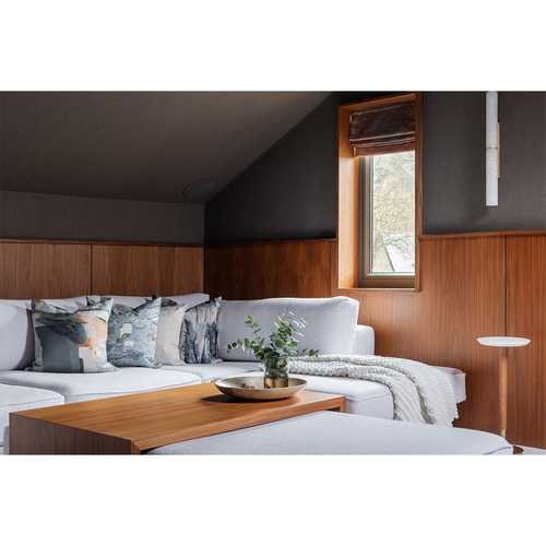 Considered Design. Push-release panels conceal hidden storage within the eaves of this cinema room, whilst the footstool twists to convert the bespoke sofa into a super-size bed for sleepovers.